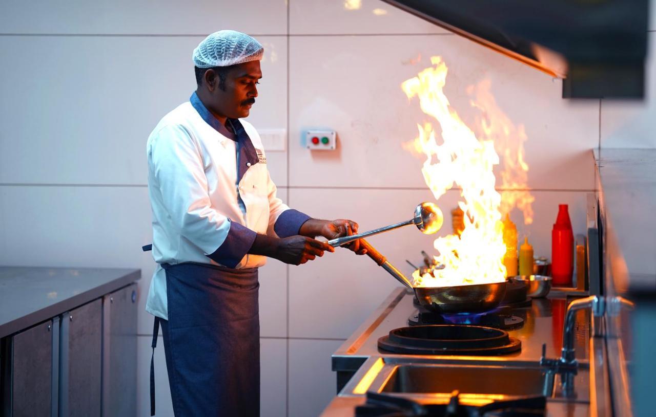 Elephant Passage Munnar Exterior photo A chef cooking with a blowtorch